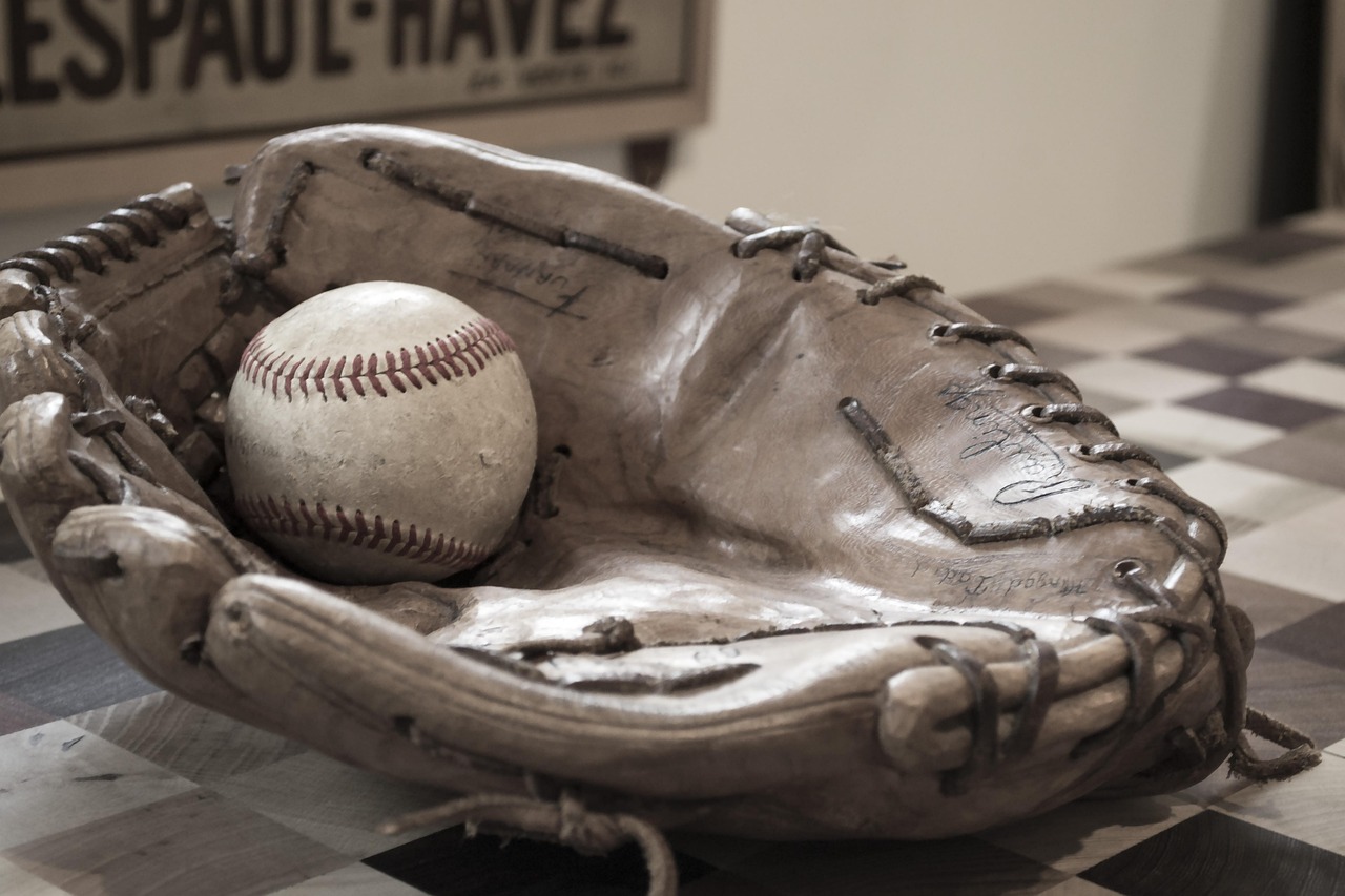 an old vintage baseball and gloves
