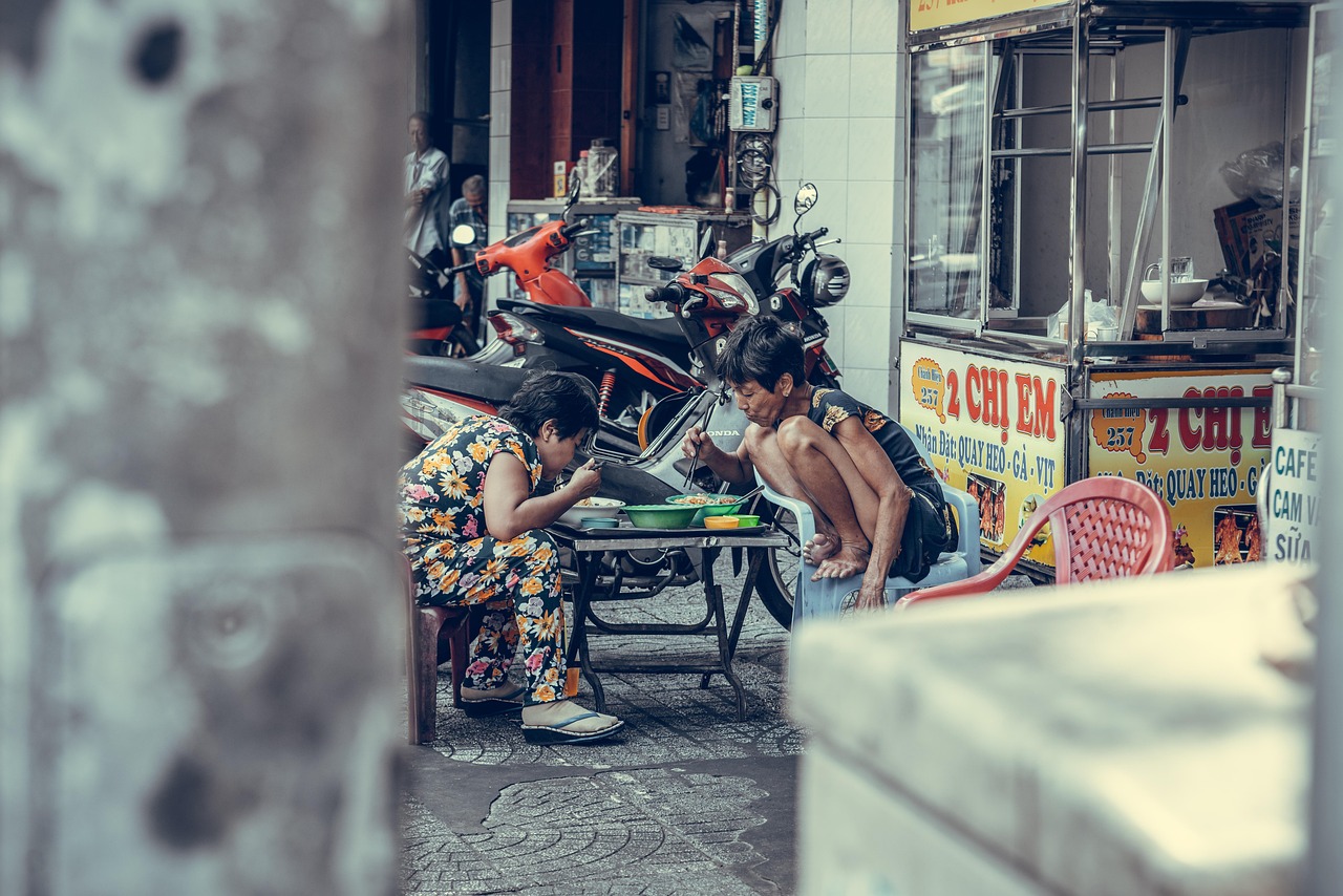 two people eating vietnamese street food