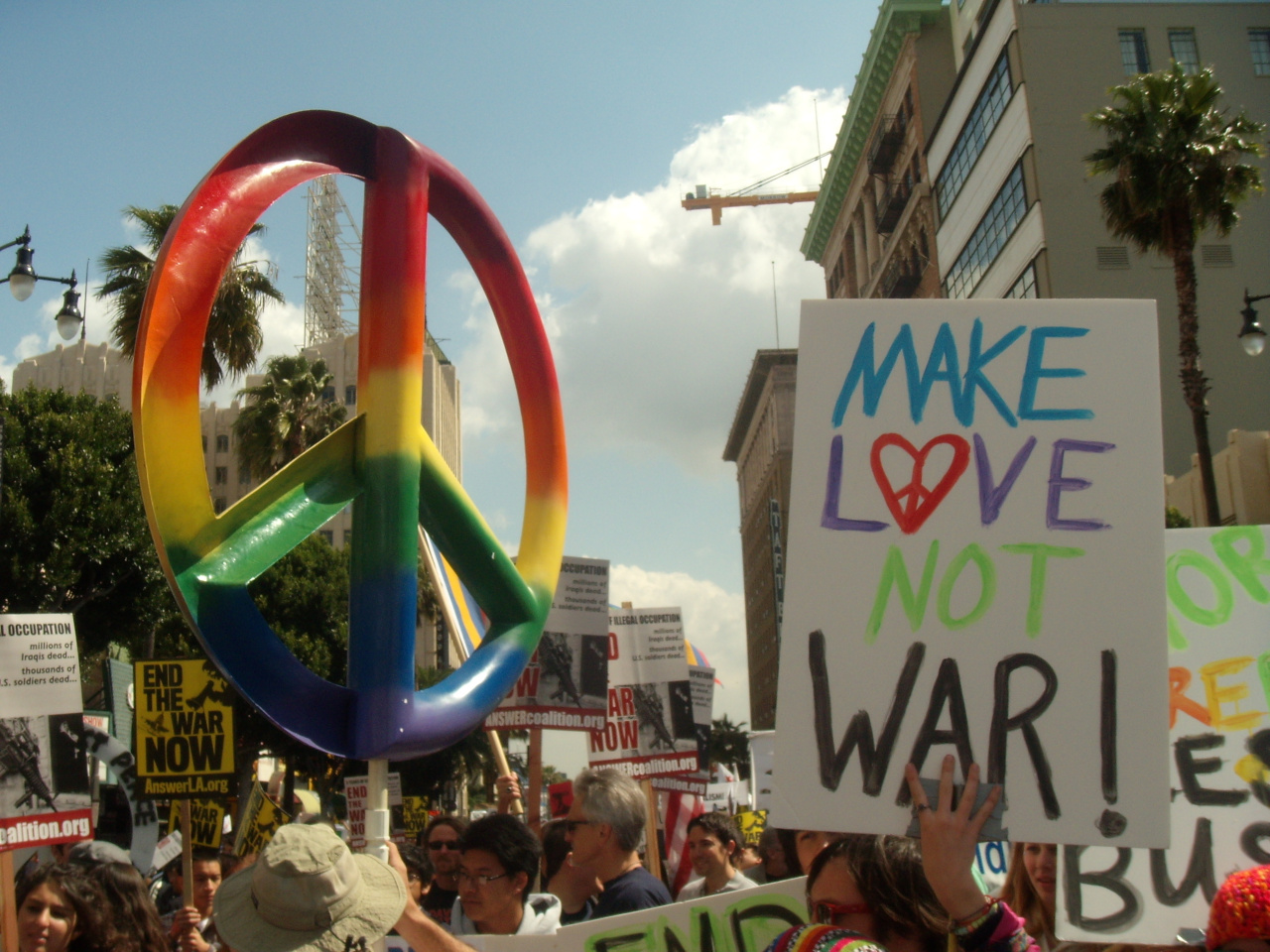 protestors holding a make love not war sign