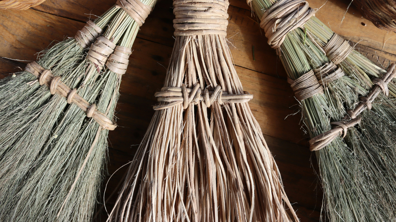 three brooms on a wooden floor