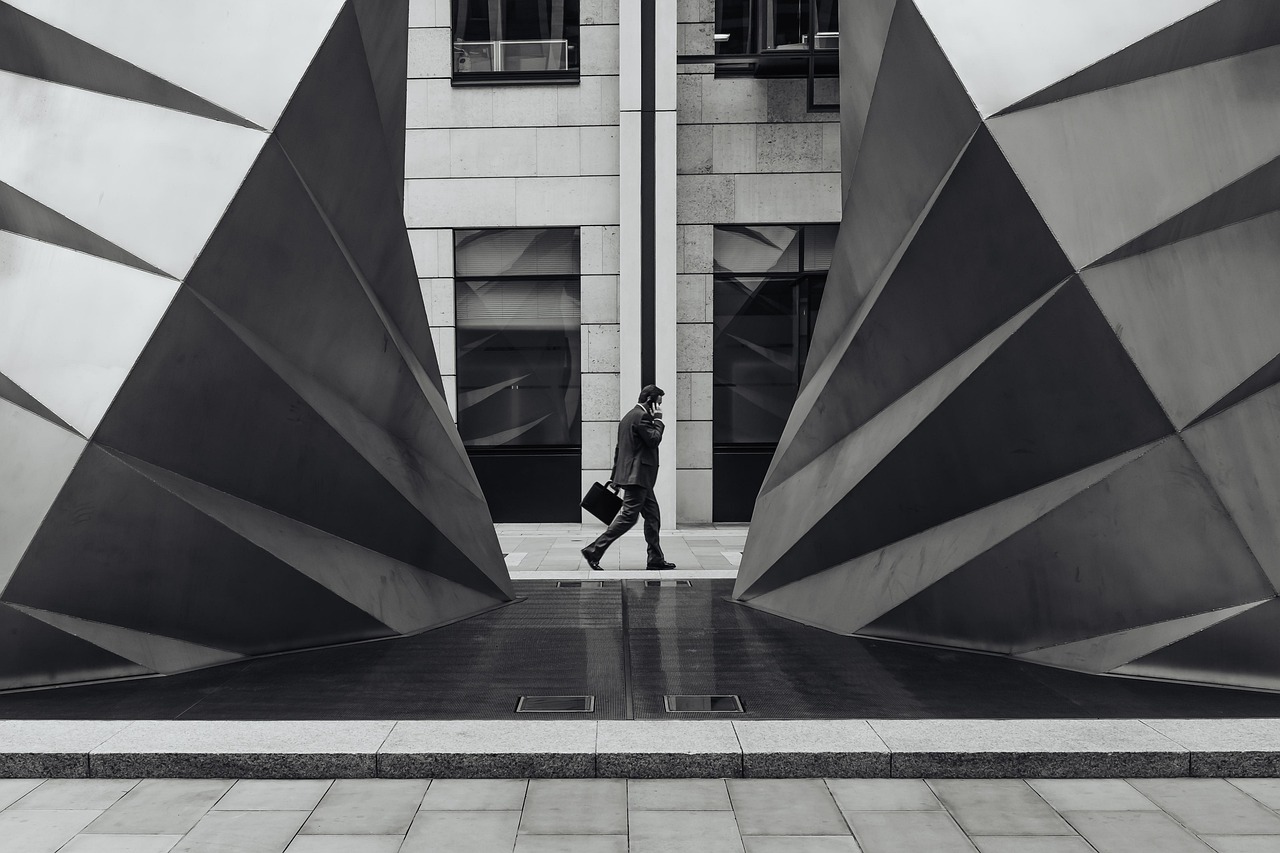 businessman walking through abstract black and white architecture
