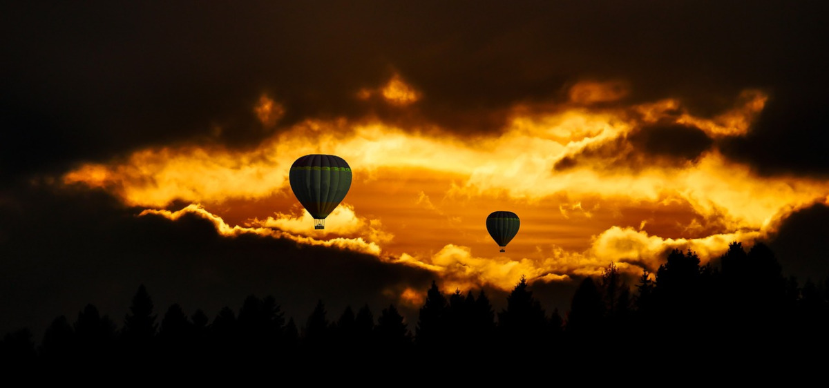 hot air balloons flying during sunset