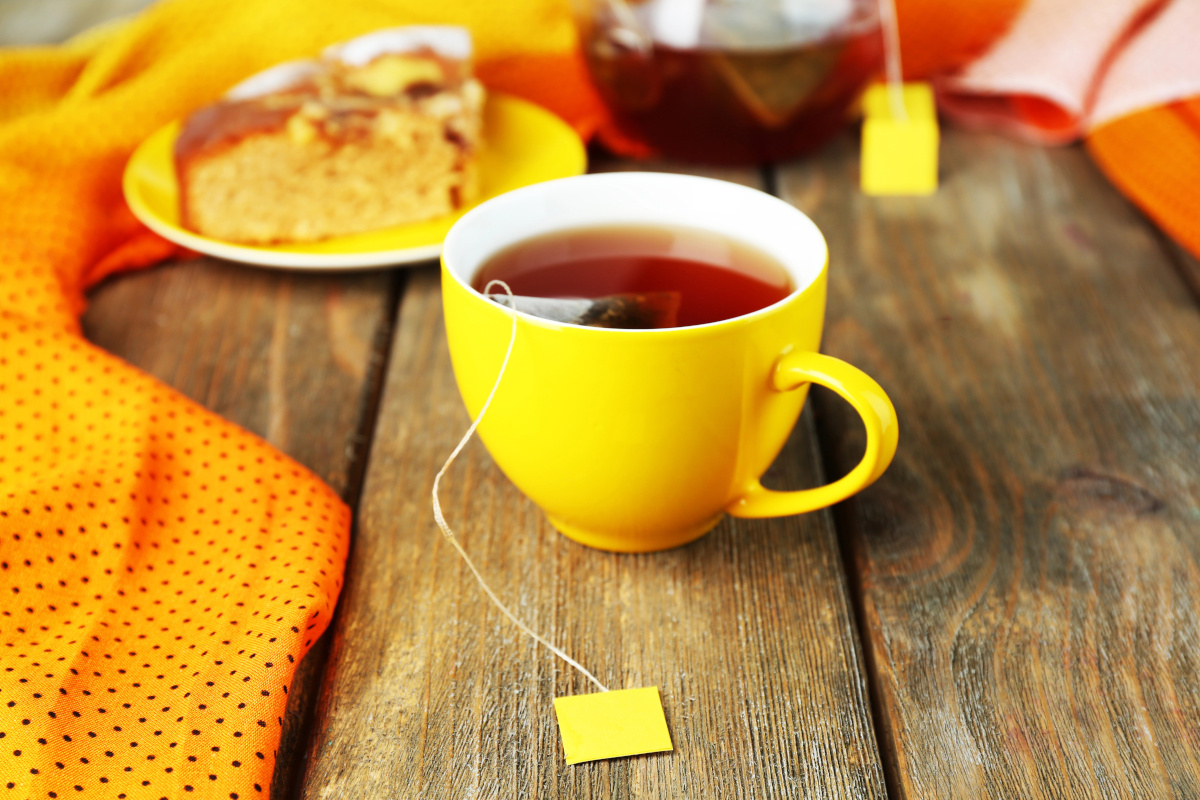 yellow teacup on wooden table