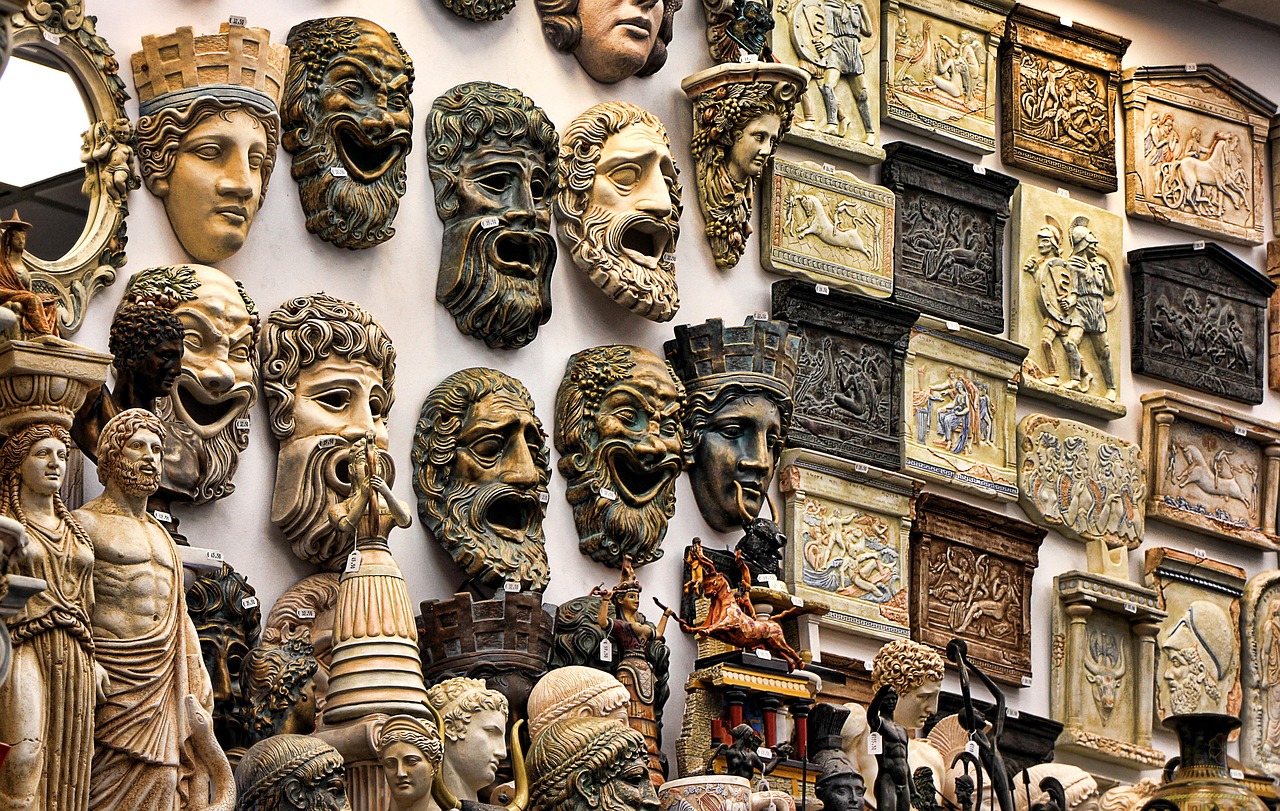 masks of greek gods on a wall