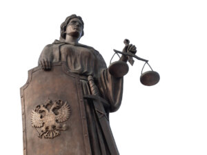 Goddess of justice Themis with a shield isolated on white background