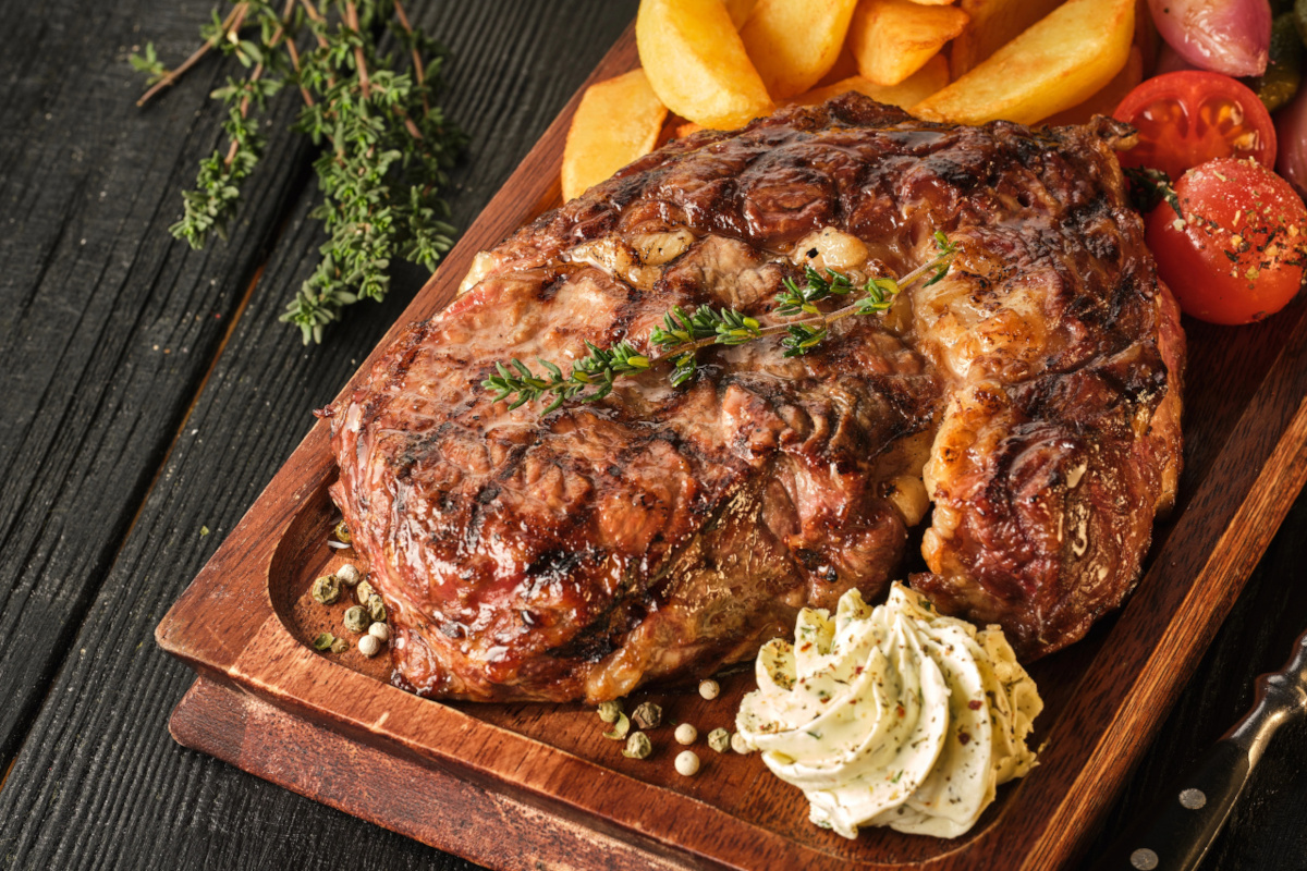 Ribeye steak with potatoes, onions and baked cherry tomatoes