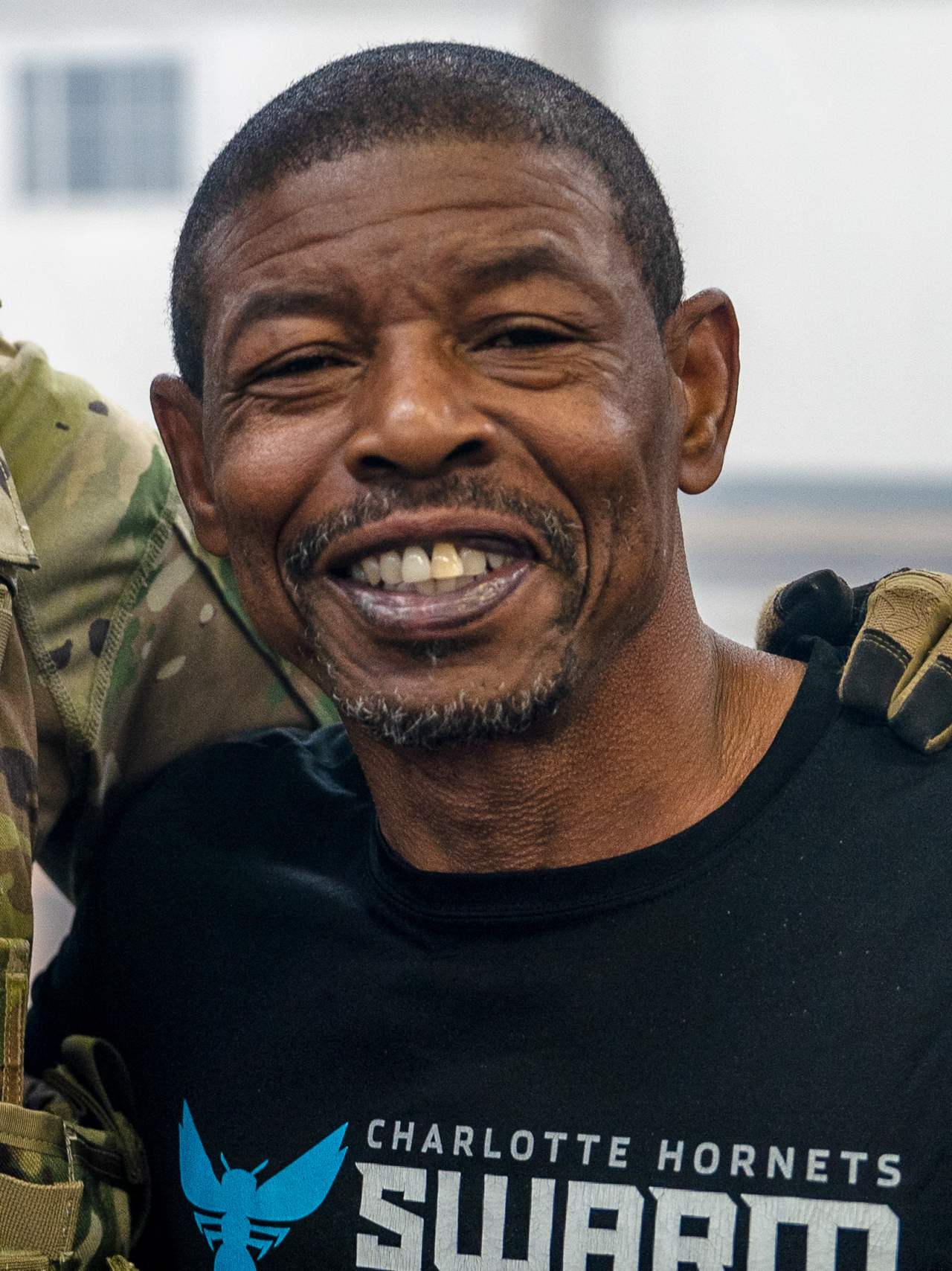 Tyrone Muggsy Bogues during an unexpected visit from NBA legends Mario Chalmers, Jerome Williams, and Michael Cooper while conducting vehicle rollover training at Camp Buehring, Kuwait
