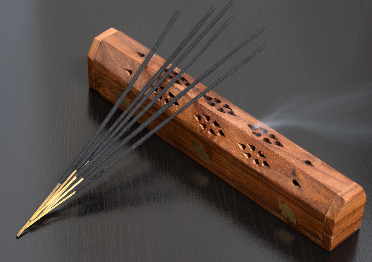 indian incense sticks and holder on black background