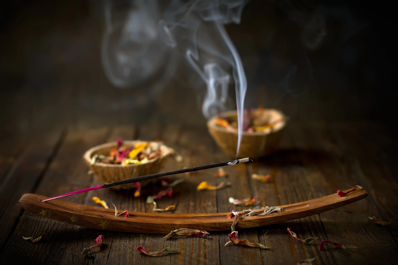 indian incense sticks on a curved incense burner