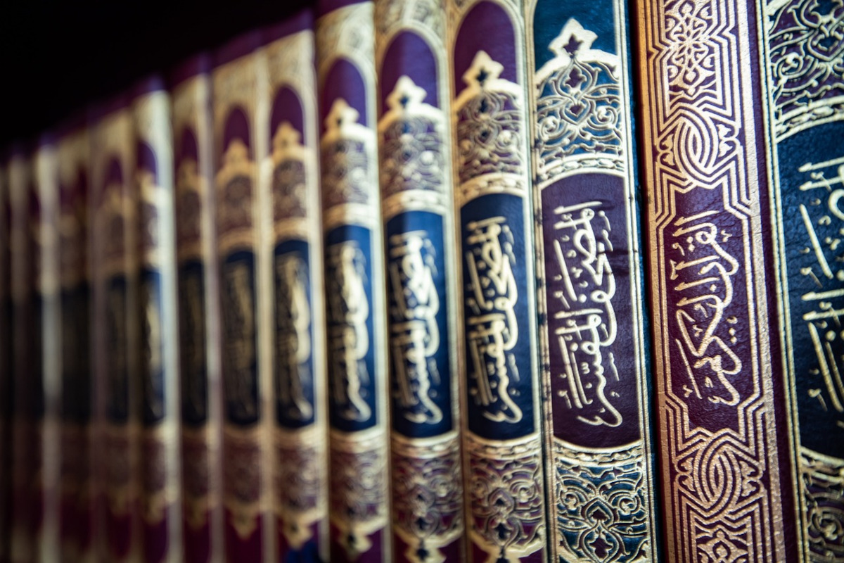 row of quran books on a shelf