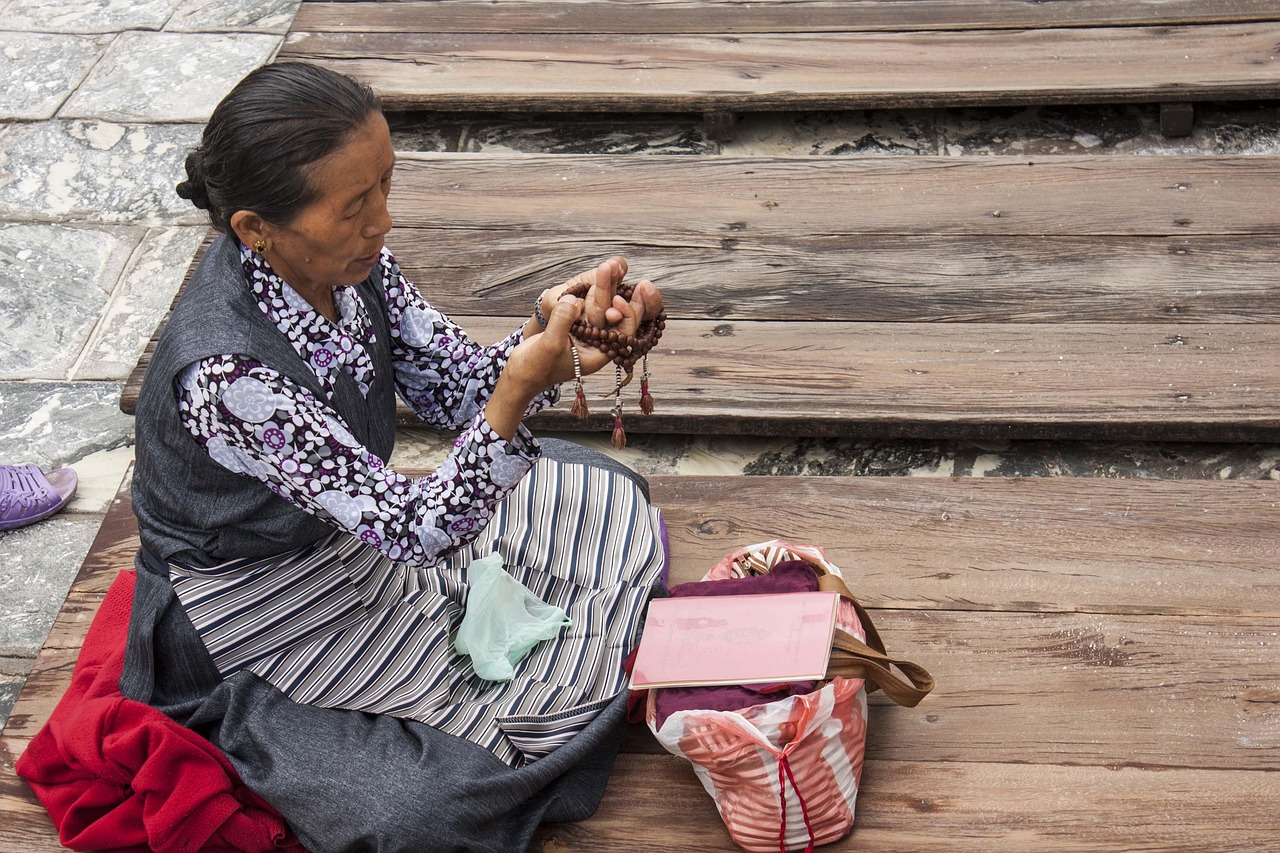 woman with prayer beads at a temple